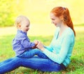 Portrait happy smiling mother and son child outdoors in sunny park Royalty Free Stock Photo