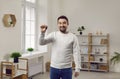 Portrait of a happy, smiling owner holding the key to his new house or apartment Royalty Free Stock Photo