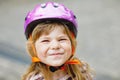 Portrait of happy smiling preschool girl with bycicle helmet on head. Cute toddler child. Safe bike driving with Royalty Free Stock Photo