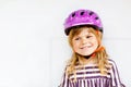 Portrait of happy smiling preschool girl with bycicle helmet on head. Cute toddler child. Safe bike driving with Royalty Free Stock Photo