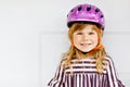 Portrait of happy smiling preschool girl with bycicle helmet on head. Cute toddler child. Safe bike driving with Royalty Free Stock Photo