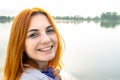 Portrait of happy smiling red haired girl. Positive young woman looking in camera outdoors Royalty Free Stock Photo