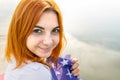 Portrait of happy smiling red haired girl. Positive young woman looking in camera outdoors Royalty Free Stock Photo