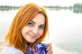 Portrait of happy smiling red haired girl. Positive young woman looking in camera outdoors Royalty Free Stock Photo