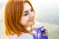 Portrait of happy smiling red haired girl. Positive young woman looking in camera outdoors Royalty Free Stock Photo