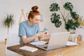 Portrait of happy smiling redhead young woman using phone. Royalty Free Stock Photo