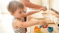 Portrait of happy smiling toddler boy with young mother baking and cooking on kitchen. Parent teaching and educating Royalty Free Stock Photo