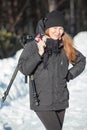 Portrait of happy smiling woman assistant holding tripod, winter season Royalty Free Stock Photo