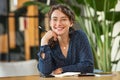 Portrait of happy smiling woman at desk