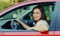 Portrait of happy smiling woman driver behind wheel red car Royalty Free Stock Photo