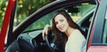 Portrait of happy smiling woman driver behind wheel red car Royalty Free Stock Photo