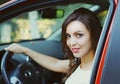 Portrait of happy smiling woman driver behind wheel red car Royalty Free Stock Photo