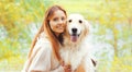 Portrait happy smiling woman with her Golden Retriever dog together in sunny autumn Royalty Free Stock Photo