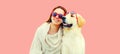 Portrait of happy smiling woman with her Golden Retriever dog wearing sunglasses on pink background Royalty Free Stock Photo