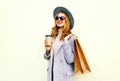 Portrait happy smiling woman with shopping bags, holding coffee cup, wearing pink coat, round hat Royalty Free Stock Photo