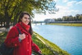 Portrait of happy smiling woman standing near the city river