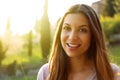 Portrait of happy smiling woman standing on sunny summer or spring day outside. Cute smiling woman looking to the side filtered