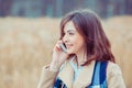 Portrait happy smiling woman talking on mobile cell phone standing outdoor near university park. Business woman having Royalty Free Stock Photo