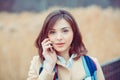 Portrait happy smiling woman talking on mobile cell phone standing outdoor near university park. Business woman having Royalty Free Stock Photo