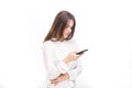 Portrait happy, smiling woman texting on her smart phone, isolated white background. Communication concept. Internet, phone addict Royalty Free Stock Photo