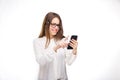 Portrait happy, smiling woman texting on her smart phone, isolated white background. Communication concept. Internet, phone addict Royalty Free Stock Photo