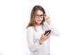 Portrait happy, smiling woman texting on her smart phone, isolated white background. Communication concept. Internet, phone addict Royalty Free Stock Photo