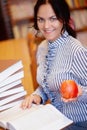 Portrait of happy smiling young brunette student girl with apple Royalty Free Stock Photo
