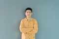 Portrait of happy smiling young business Asian, Chinese man person standing isolated in fashion design concept on gray background Royalty Free Stock Photo