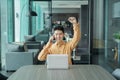 Portrait of happy smiling young business Asian, Chinese man person using laptop computer, working, and talking on smart mobile Royalty Free Stock Photo