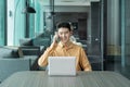 Portrait of happy smiling young business Asian, Chinese man person using laptop computer, working, and talking on smart mobile Royalty Free Stock Photo