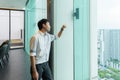 Portrait of happy smiling young business Asian, Chinese man person working, touching, and looking at the window in meeting room in Royalty Free Stock Photo