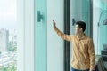 Portrait of happy smiling young business Asian, Chinese man person working, touching, and looking at the window in meeting room in Royalty Free Stock Photo