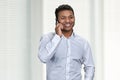 Portrait of happy smiling young businessman talking on mobile phone. Royalty Free Stock Photo