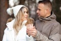 Portrait of happy smiling young couple in casual upper garments stand meeting eyes, holding hands, showing wedding ring. Royalty Free Stock Photo