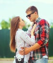 Portrait of happy smiling young couple hugging and looking at each other in summer city park Royalty Free Stock Photo