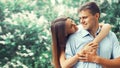 Portrait of happy smiling young couple in love in blooming spring garden park Royalty Free Stock Photo