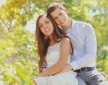 Portrait of happy smiling young couple together outdoors in park Royalty Free Stock Photo