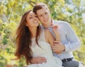 Portrait of happy smiling young couple together outdoors in park Royalty Free Stock Photo