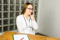 Portrait of happy smiling young doctor with cellphone Royalty Free Stock Photo