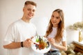 Portrait of happy smiling young pretty couple stand closely, posing, holding watercolor palette and brushes. Art therapy Royalty Free Stock Photo