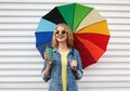 Portrait happy smiling young woman with colorful umbrella and cup of coffee on a white background Royalty Free Stock Photo