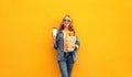 Portrait of happy smiling young woman holding grocery shopping paper bag with long white bread baguette and cup of coffee on Royalty Free Stock Photo