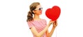 Portrait of happy smiling young woman holding red heart shaped balloon isolated on white background Royalty Free Stock Photo