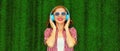 Portrait of happy smiling young woman listening to music in headphones relaxing lying on the grass background in summer park Royalty Free Stock Photo