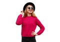 Portrait of happy smiling young woman model wearing pink knitted sweater and black round hat isolated on white background Royalty Free Stock Photo