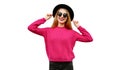 Portrait of happy smiling young woman model wearing pink knitted sweater and black round hat isolated on white background Royalty Free Stock Photo