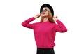 Portrait of happy smiling young woman model wearing pink knitted sweater and black round hat isolated on white background Royalty Free Stock Photo