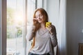 Portrait of happy smiling young woman waking up, stretching, drinking coffee, morning routine Royalty Free Stock Photo