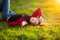 Portrait of happy sporty woman relaxing in park on green meadow. Joyful female model breathing fresh air outdoors Royalty Free Stock Photo