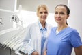 Portrait of happy stomatologist and her dental assistant